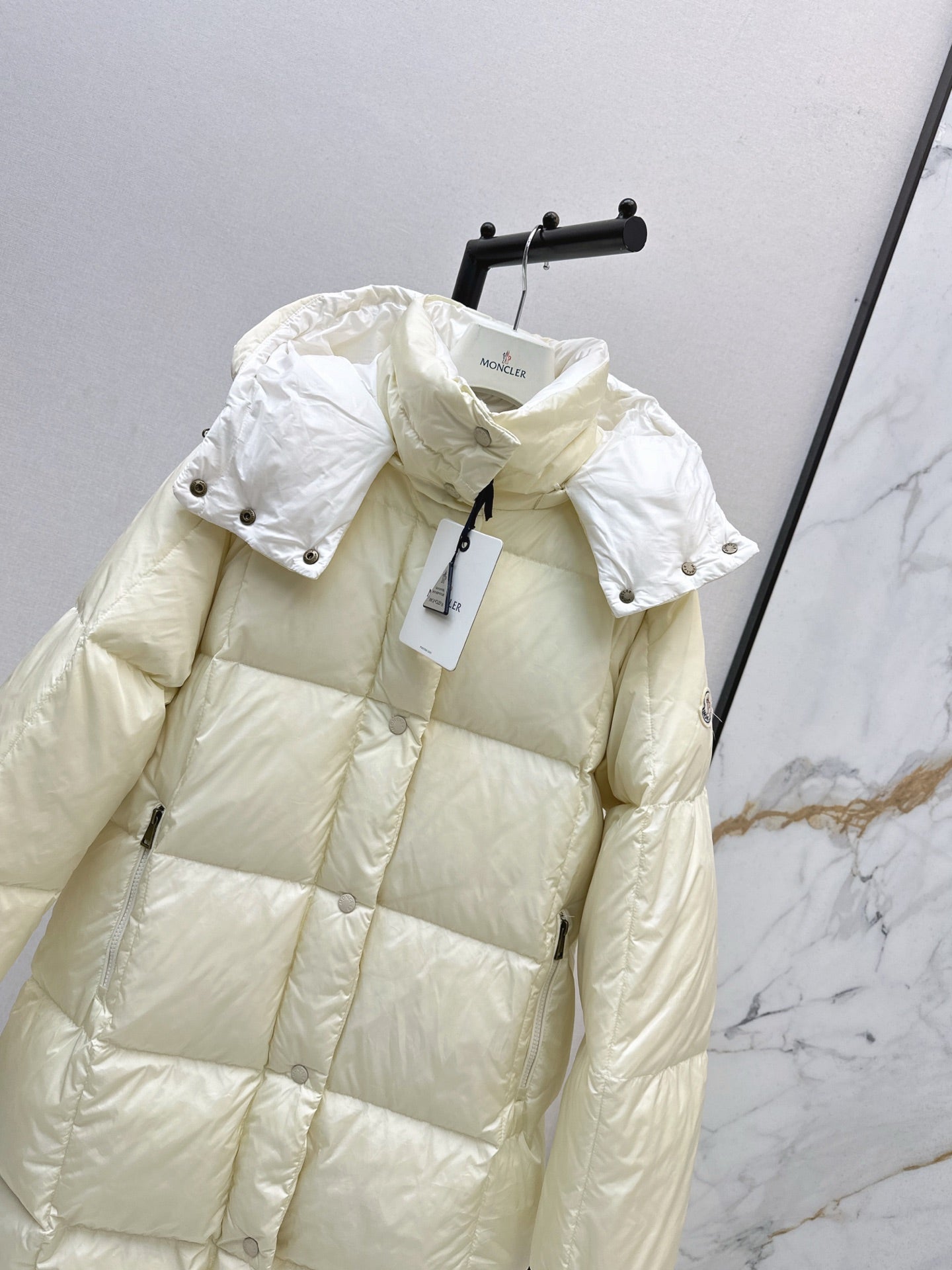 mid-length down jacket with hood and sleeve badge