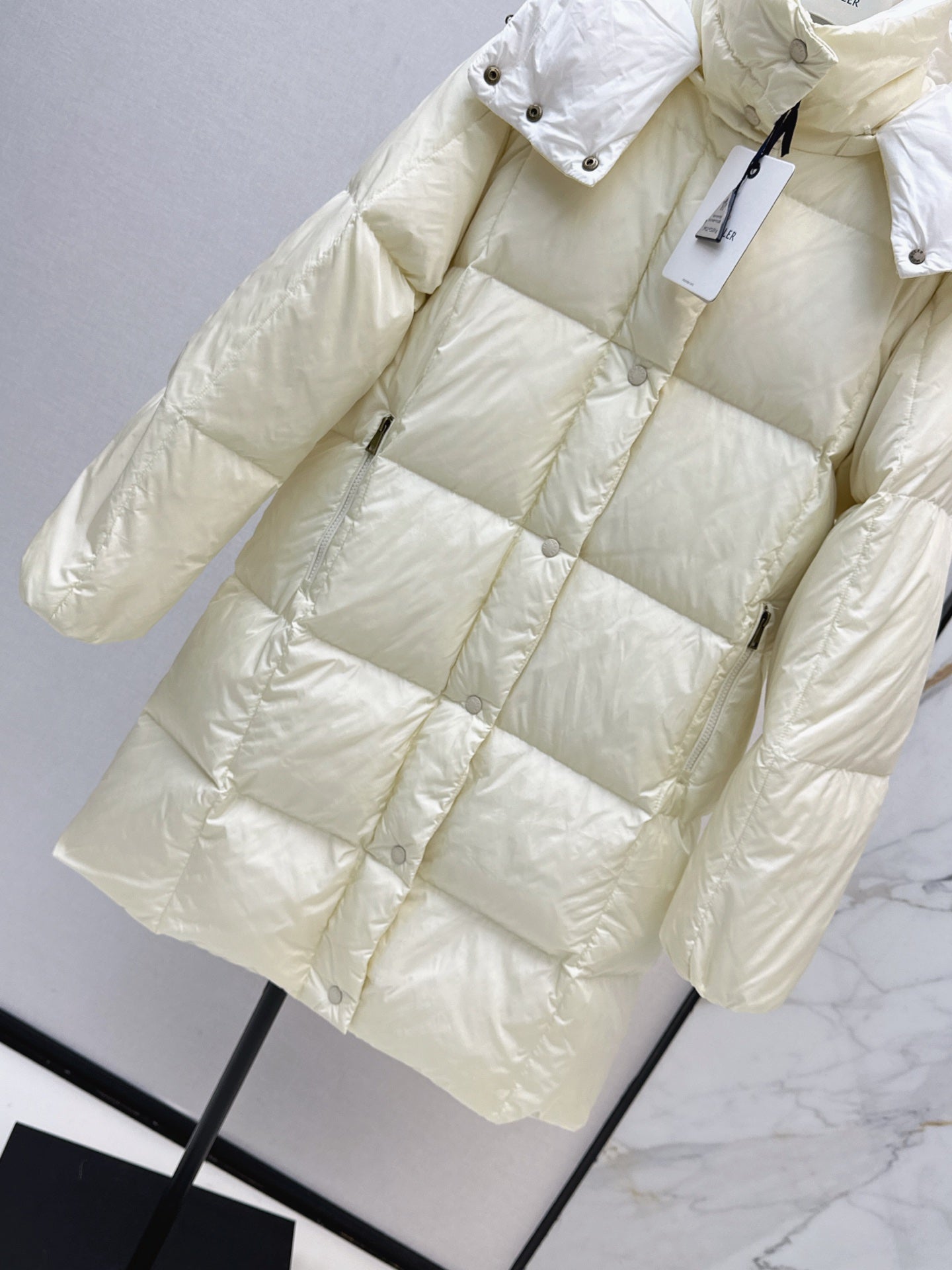 mid-length down jacket with hood and sleeve badge